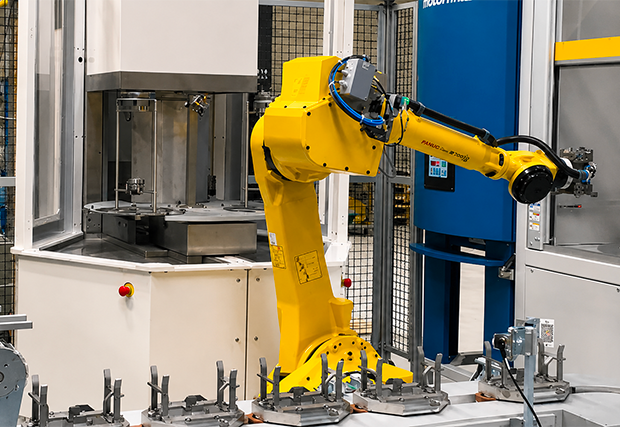 ‘MécanoFAST’ parts cleaning machine integrated into a robotic cell on a production line