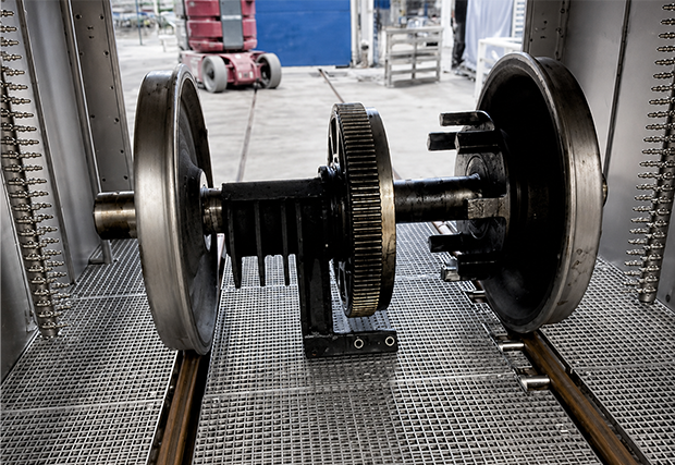 A railway axle in a degreasing and cleaning machine