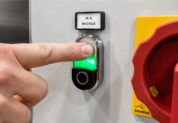 Button to activate on-demand drying on the eco-friendly coin-operated washing machine
